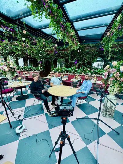Podcast conversation filmed in a bright conservatory-style studio