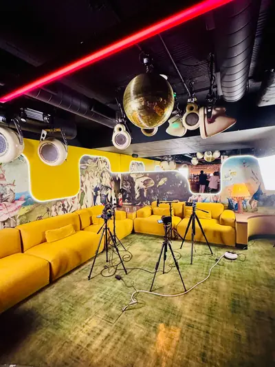 Podcast recorded on a yellow lounge set beneath a disco ball