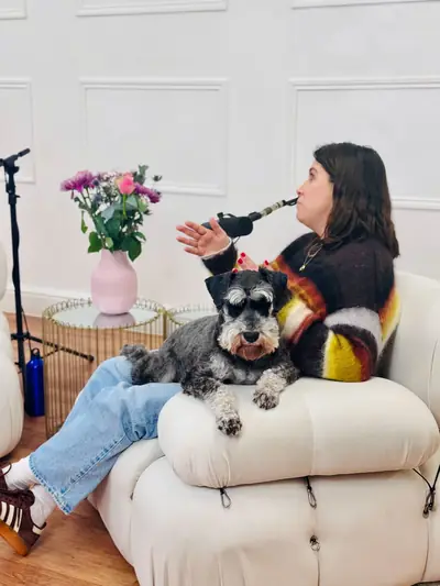 Guest with a schnauzer joining a podcast recording in the studio